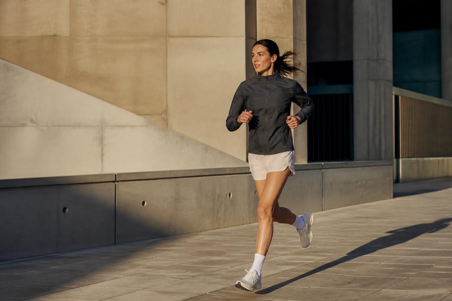 Woman running through modern city architecture